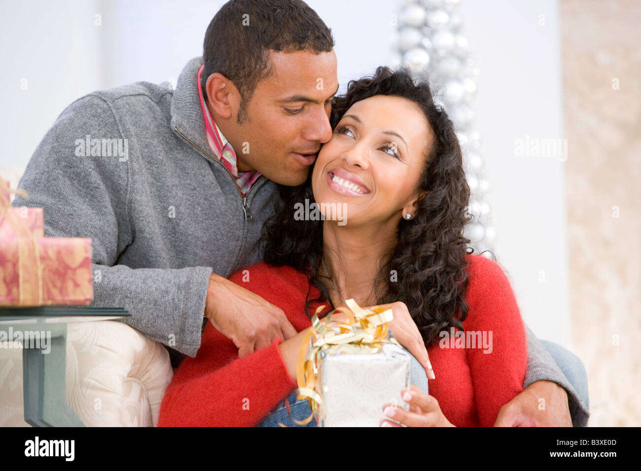 Il marito e la moglie affettuosamente lo scambio di regali di Natale Foto Stock