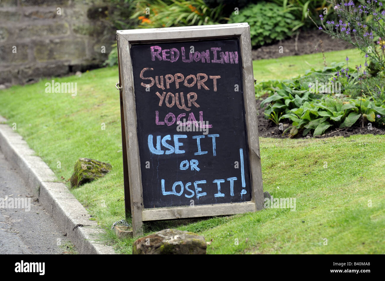 BRITISH COUNTRY public house segno dicendo 'utilizzarlo o perdere!" Foto Stock