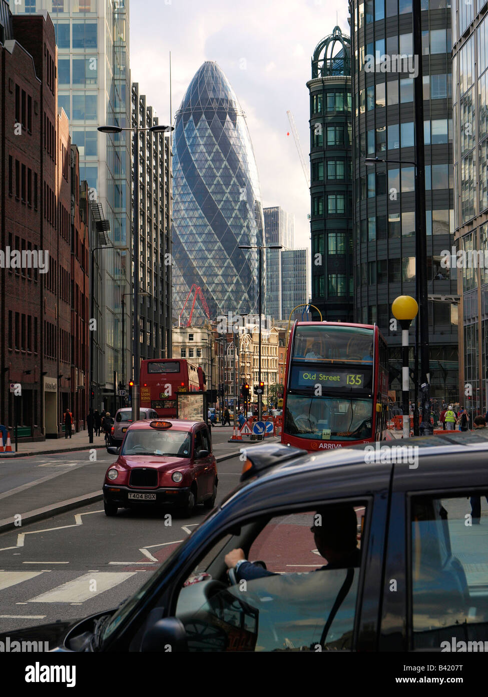 A Londra i taxi e gli autobus in Bishopsgate con il Gherkin edificio in background London City Regno Unito Foto Stock