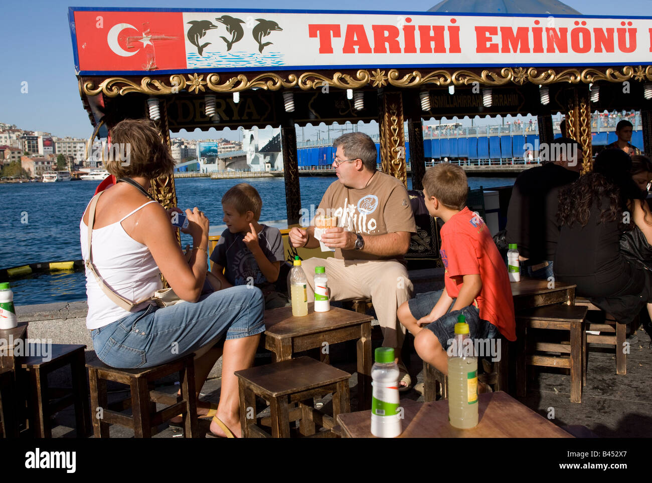 Famiglia mangiare pesce panino Balik Ekmek a Eminou Harbourside Istanbul Turchia Foto Stock