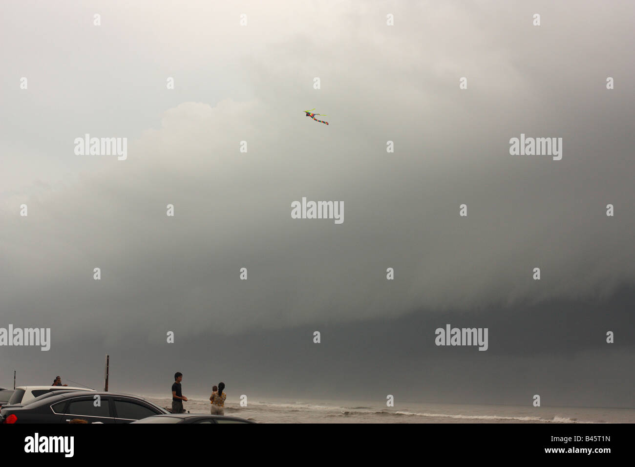 Una persona volare un aquilone come una tempesta di approcci anteriore. Foto Stock