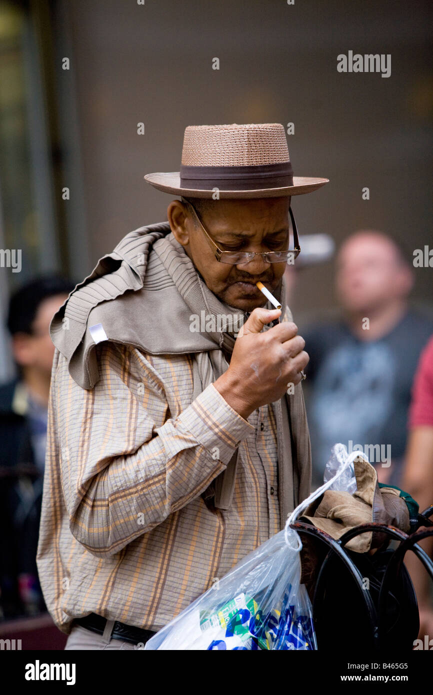 L'uomo accendere una sigaretta Scena di strada di Manhattan NY USA 2008 Foto Stock