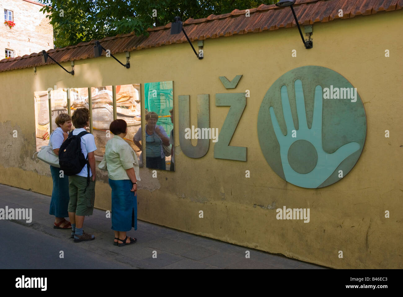 Persone che leggono la costituzione del sé dichiarata repubblica di Uzupis lungo Paupio gatve street in Vilnius Lituania Europa Foto Stock