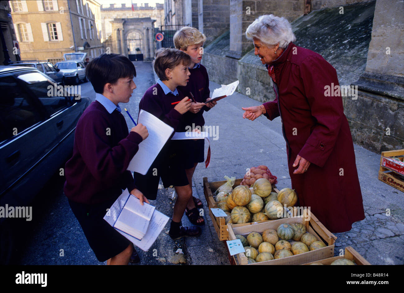 Ragazzi provare loro francese nel mercato locale Foto Stock