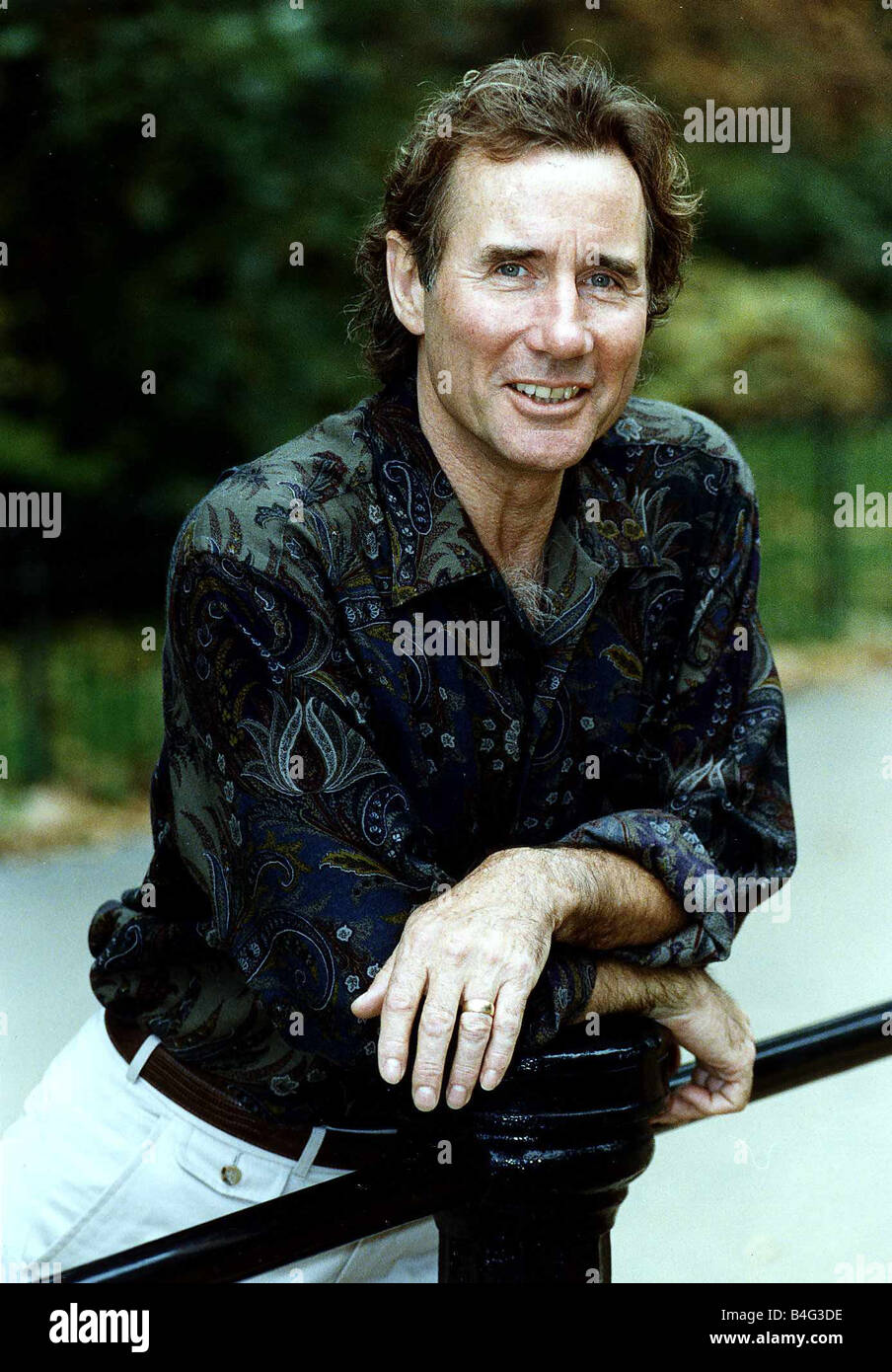 Jim Dale British commedia attore indossando Maglietta modellata appoggiata sulla ringhiera di metallo Foto Stock