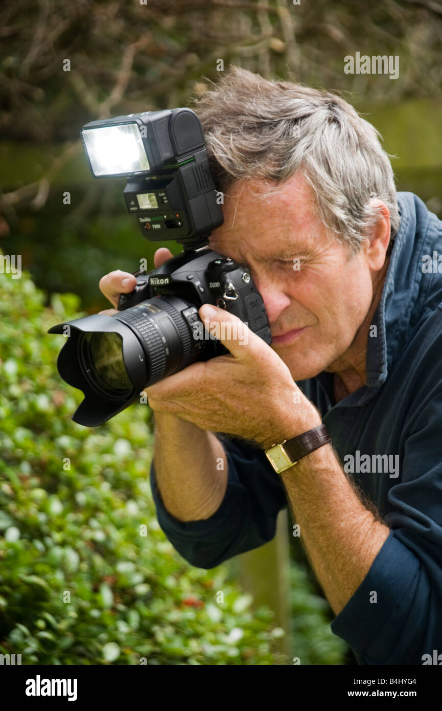 Uomo più anziano per fotografare in giardino Foto Stock