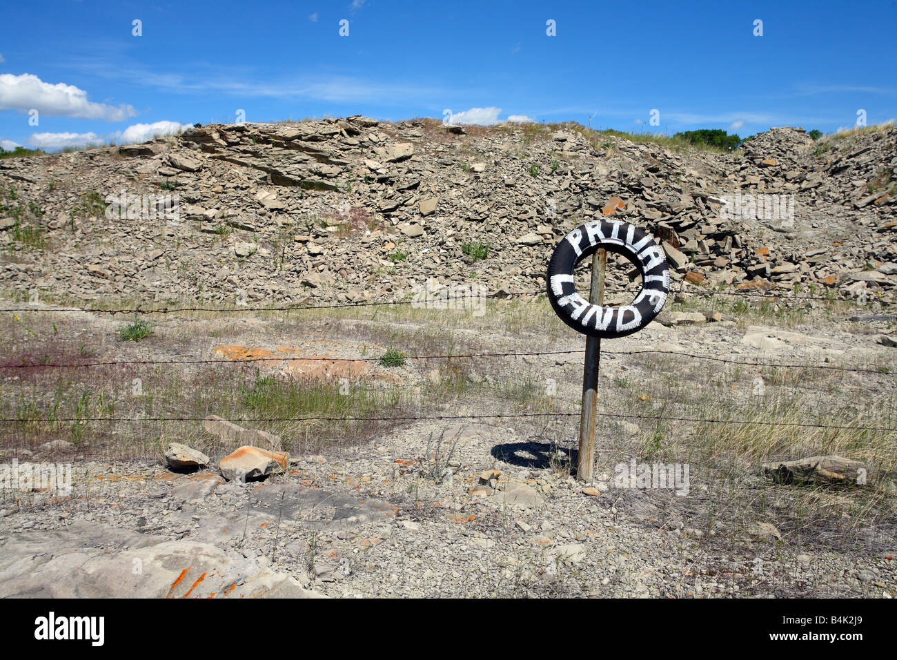 Filo spinato con pneumatici di segno dipinto di terreno privato in prossimità del rullo di estrazione Creek Alberta Canada Foto Stock
