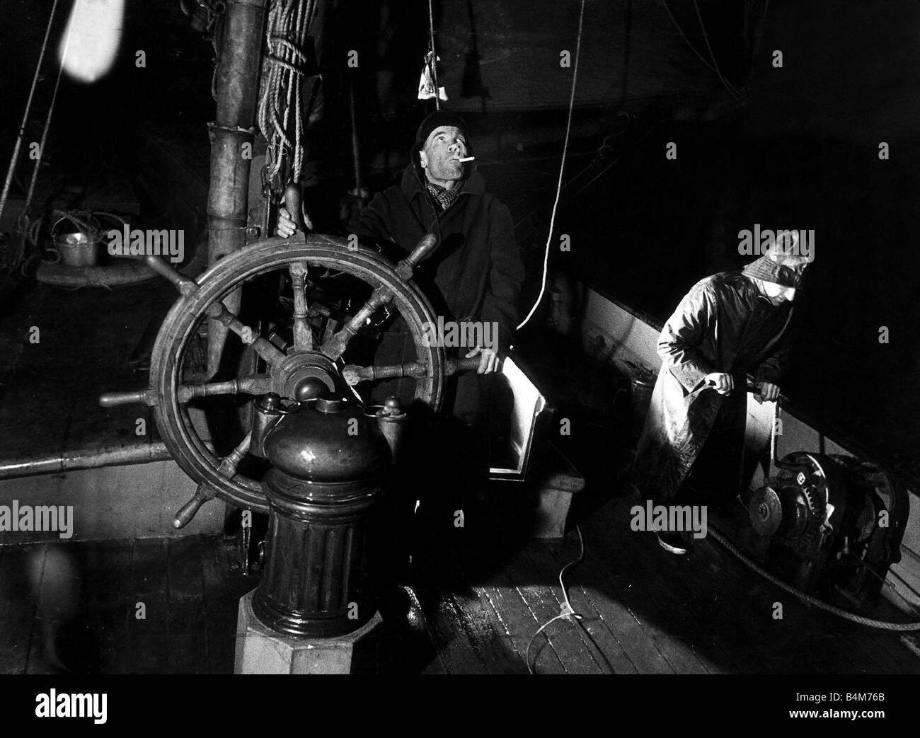 Skipper Harry Evans al volante del Tamigi chiatta a vela Ardwina come lei tornate Beachy Head nel canale in lingua inglese come il primo mate mans la pompa Aprile 1936 Foto Stock