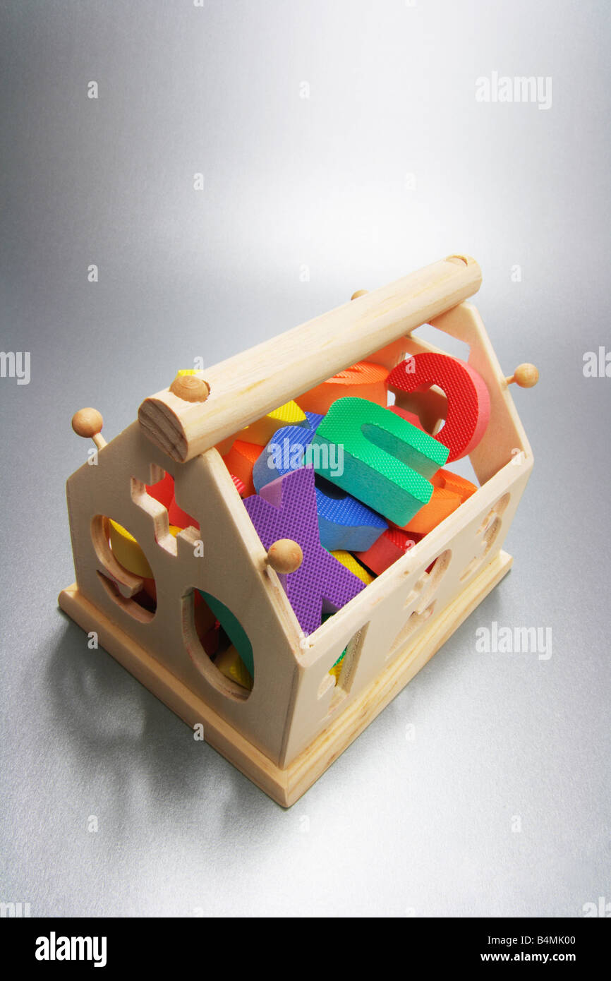 Alfabeti di plastica in casa di legno a forma di scatola di giocattoli Foto Stock