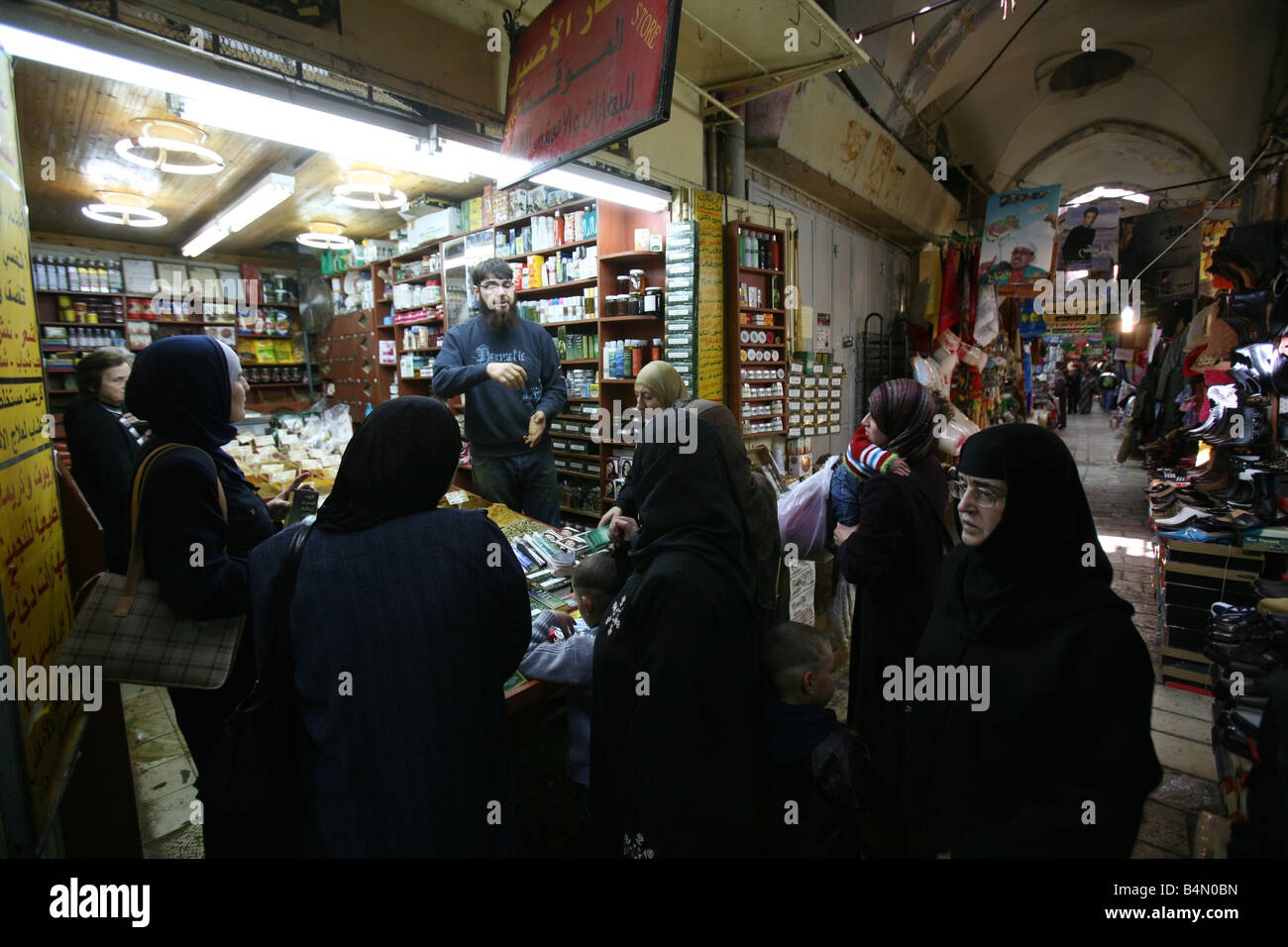 Le donne musulmane in un negozio affollato in un mercato nella città vecchia sezione di Gerusalemme Foto Stock