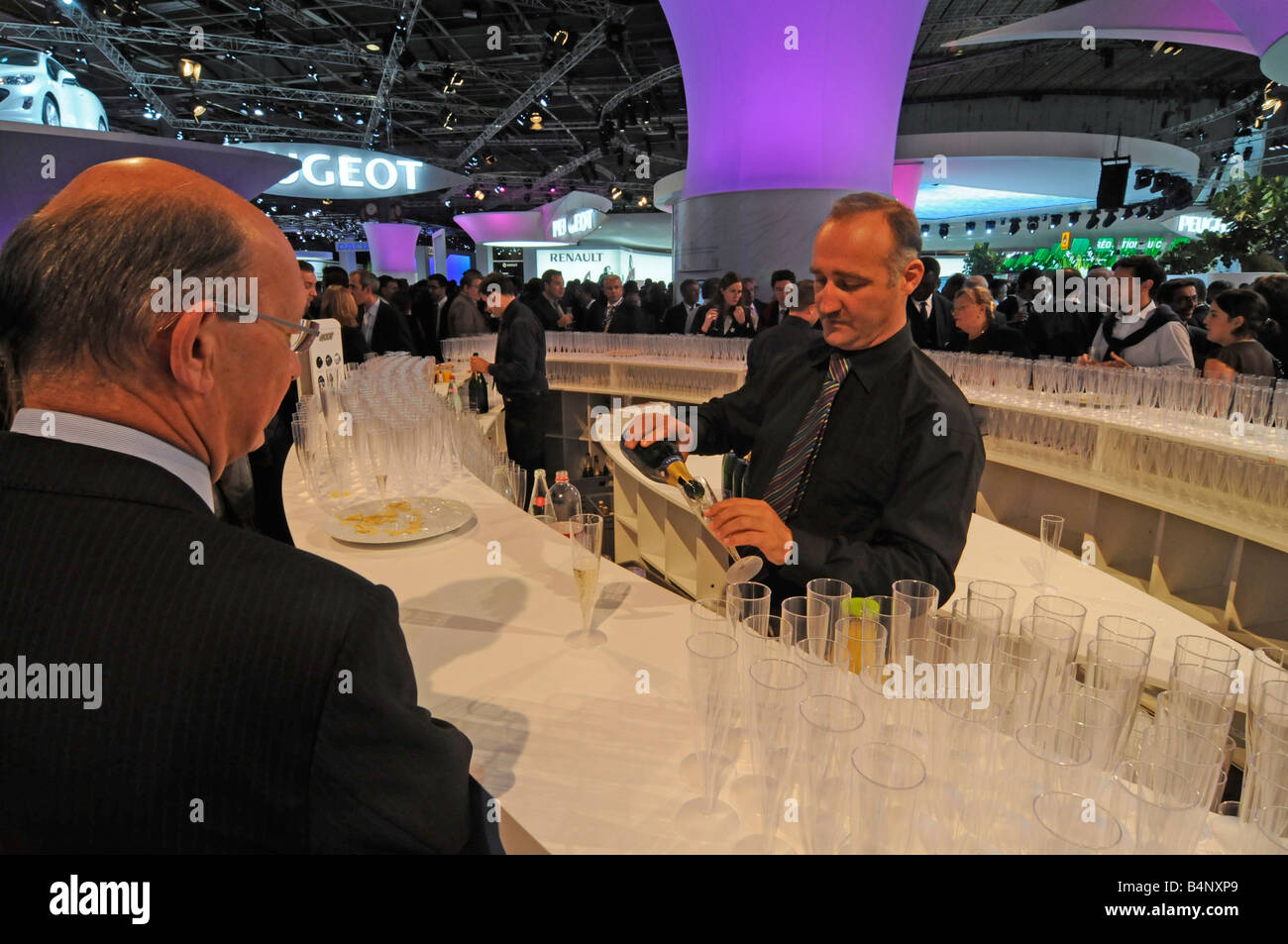 Cameriere che serve champagne francese sulla Peugeot stand durante il giorno di apertura del 'Mondial de l'Auto 2008', un motor show di Parigi Foto Stock