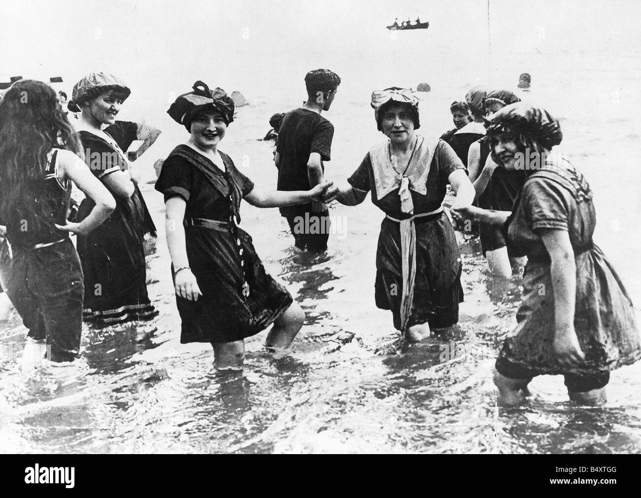 I modelli più recenti beachwear per pre guerra Inghilterra tre donne che indossano abiti e cappelli in mare Agosto 1913 Foto Stock