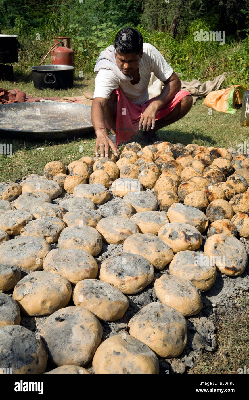 Un indiano baker rendendo il pane sulla brace del Rajasthan, India Foto Stock
