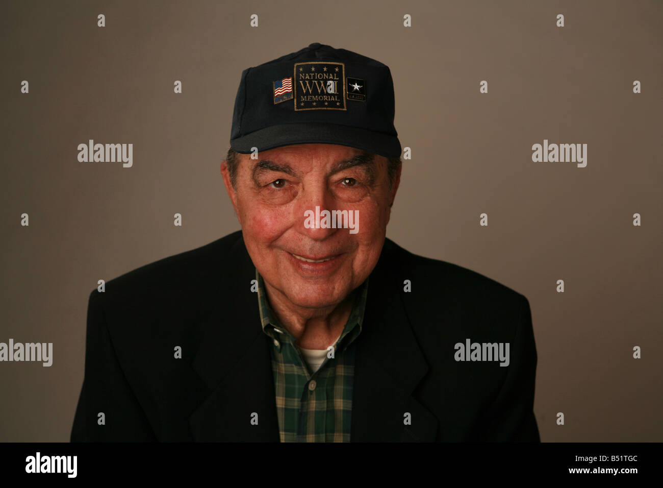 Anziani American II Guerra Mondiale veterano tenendo una bandiera americana e indossando un esercito degli Stati Uniti cap. Foto Stock