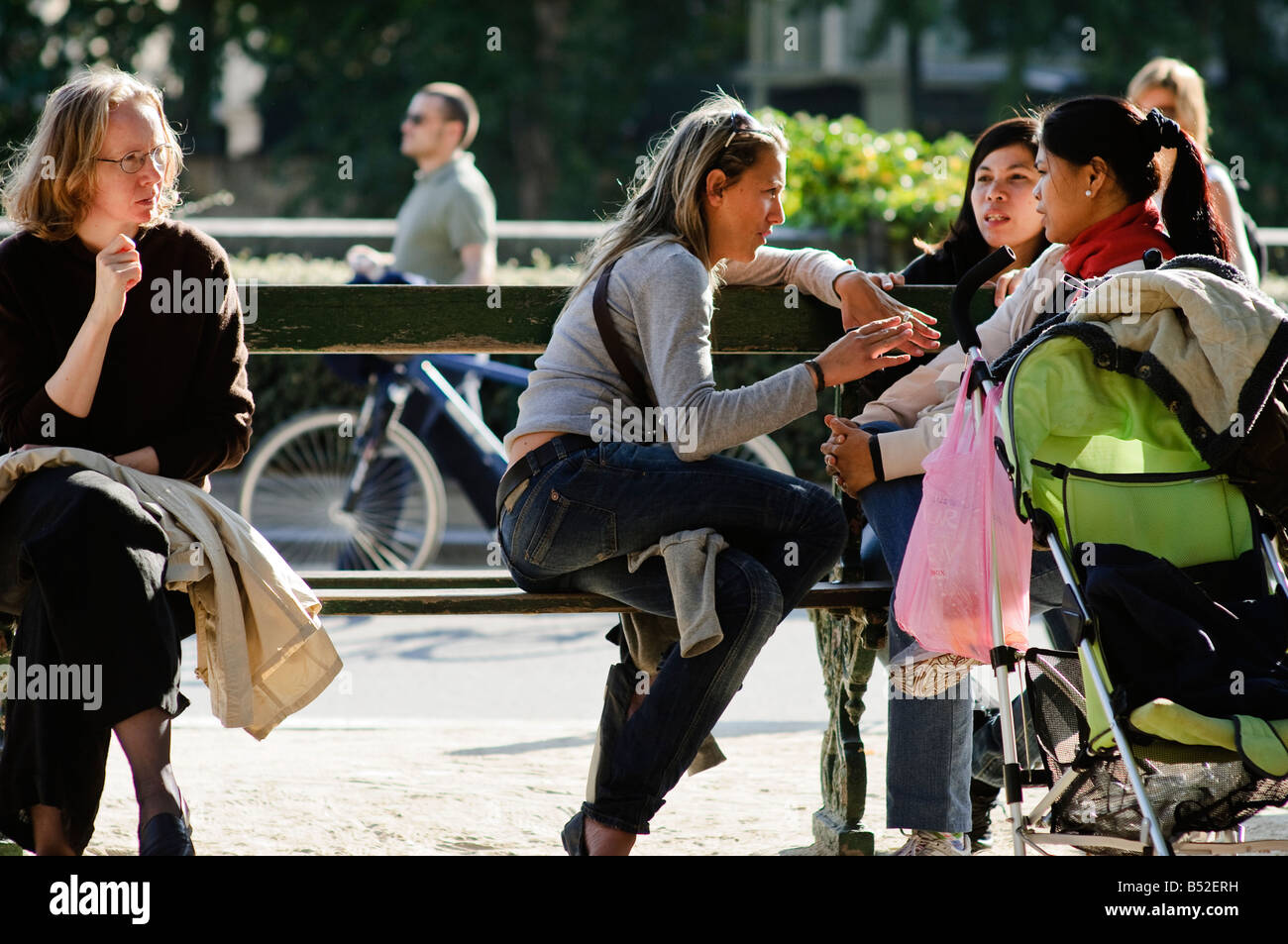 Bambinaie e madri su una panchina nel parco nei pressi del fiume Senna. Parigi, Francia. Foto Stock