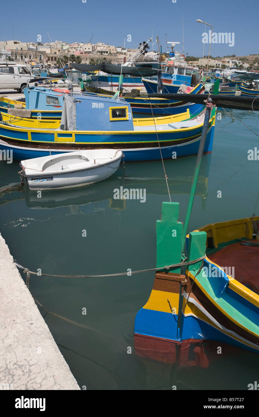 Vivacemente colorate barche da pesca chiamato Luzzus presso il villaggio di pescatori di Marsaxlokk, Malta, Mediterraneo, Europa Foto Stock