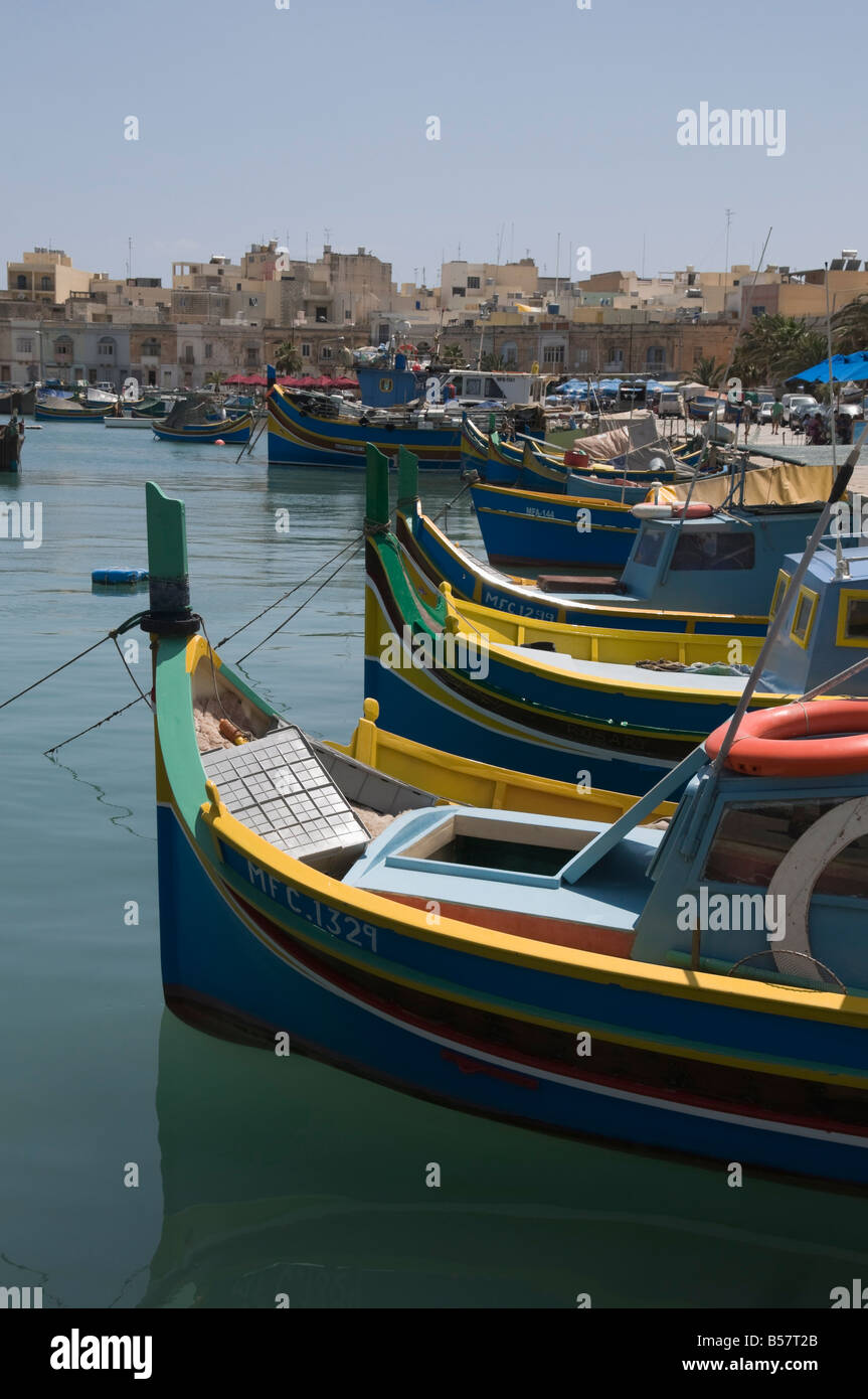 Vivacemente colorate barche da pesca chiamato Luzzus presso il villaggio di pescatori di Marsaxlokk, Malta, Mediterraneo, Europa Foto Stock