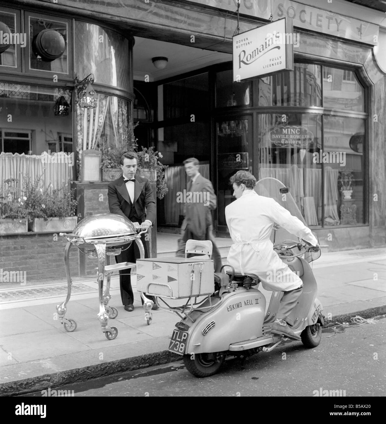 Pasti su ruote: il capo cameriere di Romain è burrosa carichi fino ai ristoranti Scooter, noto come eschimese nellâ. Romain offre un servizio a domicilio, dove i clienti possono ordinare un pasto a tre portate al telefono. 1959 A722b-004 Foto Stock