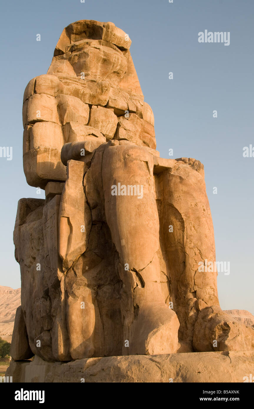 Il nord enorme Colosso di Memnon statua in pietra raffigurante il faraone Amenhotep III realizzato da blocchi di pietra arenaria quarzite vicino a Luxor, Egitto Foto Stock