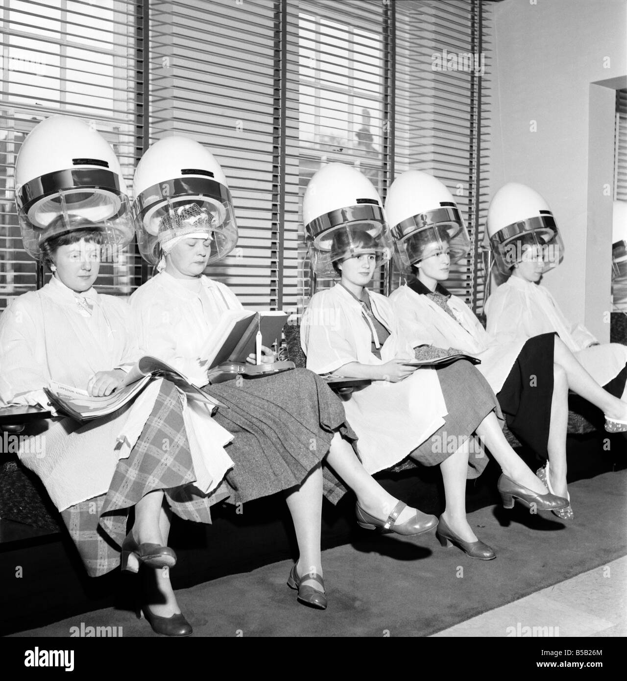 Le donne al parrucchiere visto qui sotto gli essiccatoi. Aprile 1956 Foto Stock