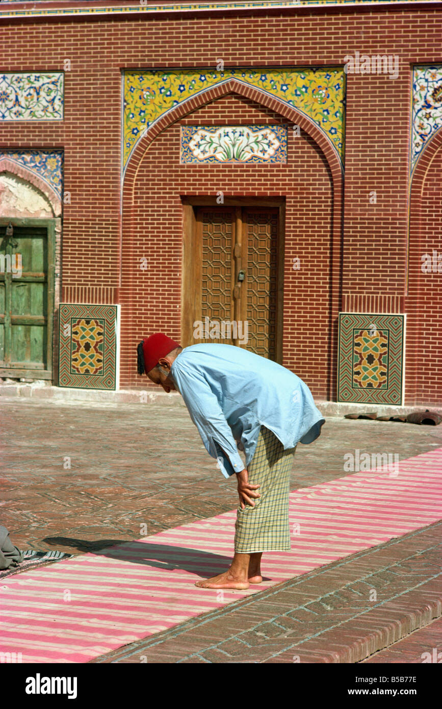 Uomo che prega Wazir Khan moschea a Lahore in Pakistan Asia Foto Stock
