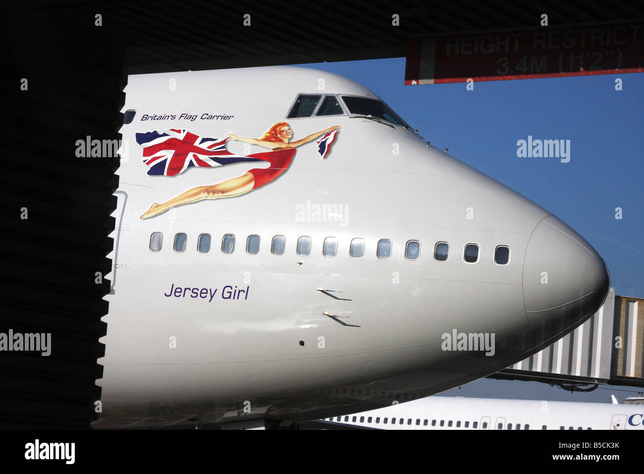 Sezione anteriore di 747 jumbo jet con compagnie aeree Jersey logo e il dipinto di lady figura. Foto Stock