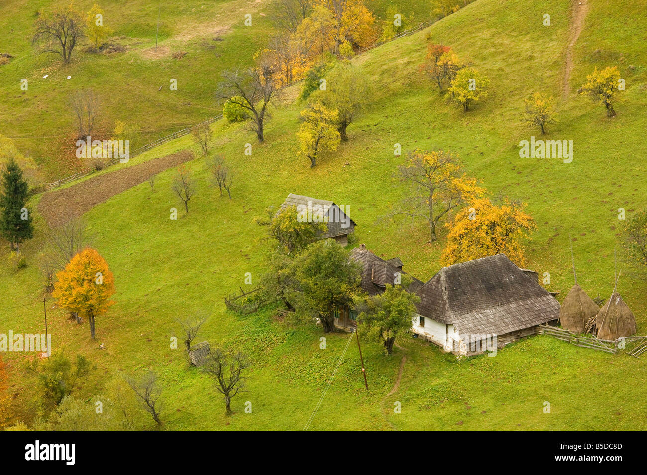 Antica fattoria in un bellissimo pastorale paesaggio montano con agricoltura tradizionale a Magura Piatra Criaulu Montagne Foto Stock