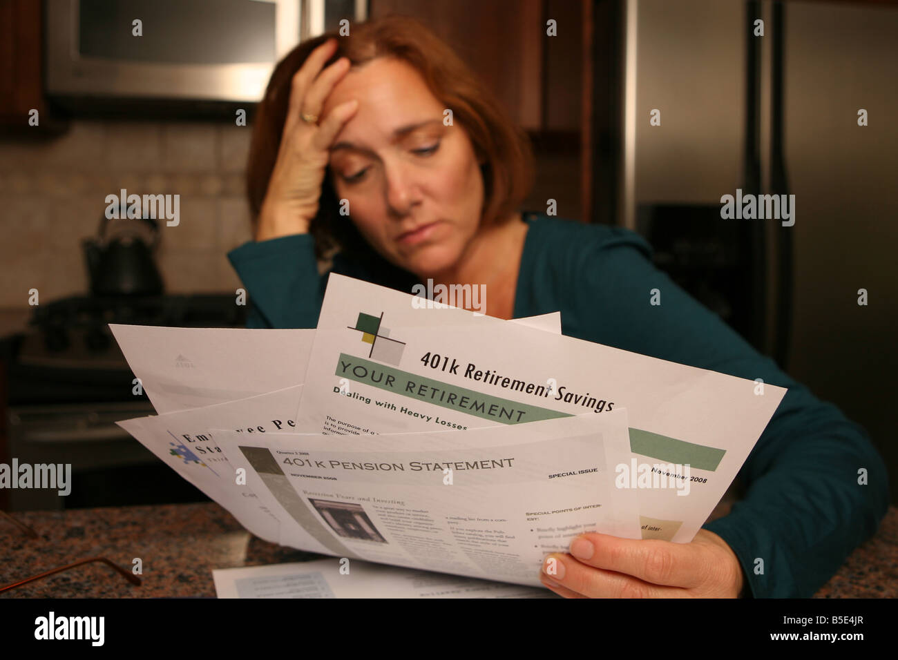 Una donna viene afferrata con preoccupazione e ansia come si guarda oltre il suo investimento dichiarazioni. Foto Stock