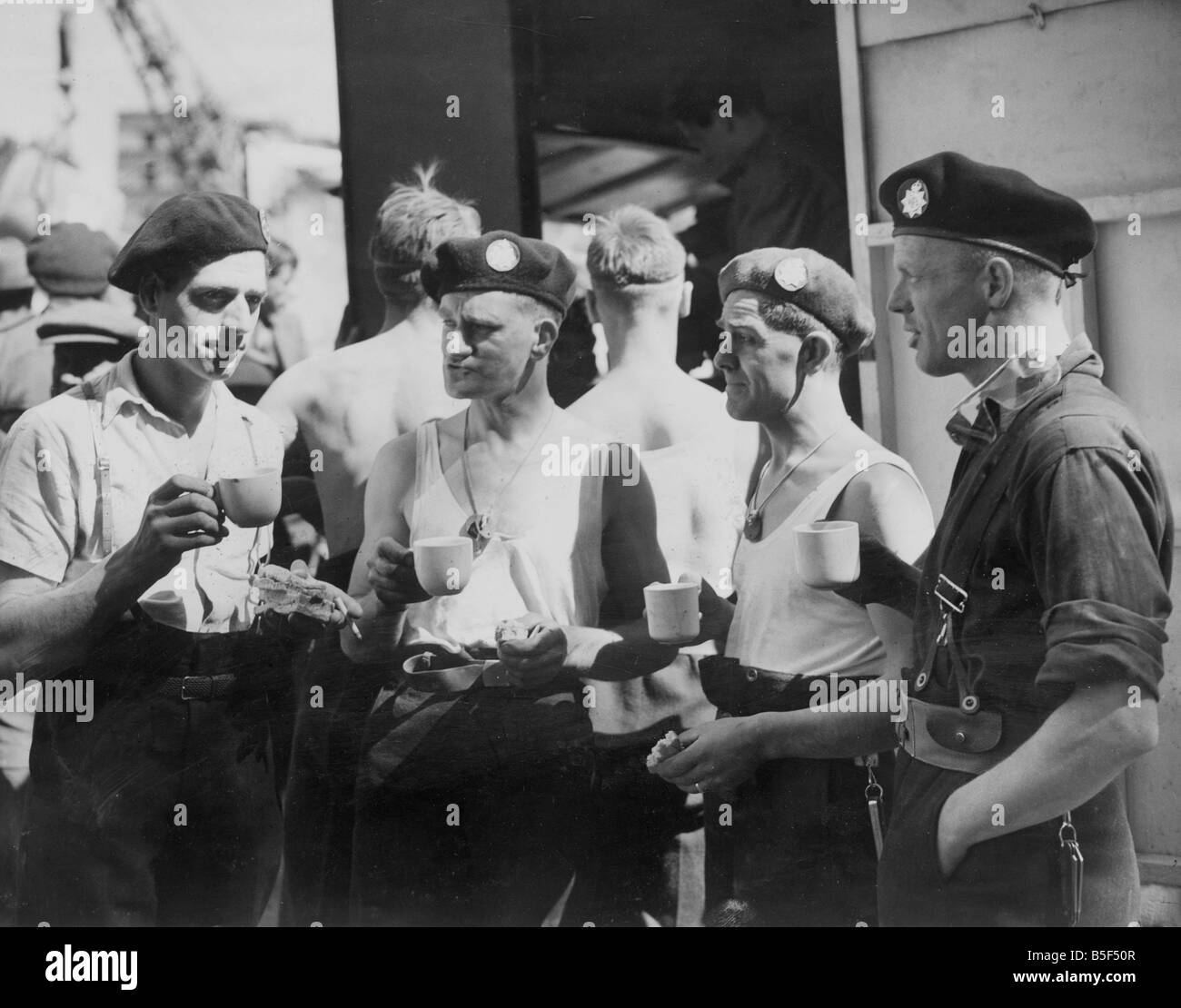 I vigili del fuoco che indossa la loro seconda berretti anteriore ad assistere i loro colleghi di lavoro di salvataggio sul sito di un incidente nel sud Engla Foto Stock
