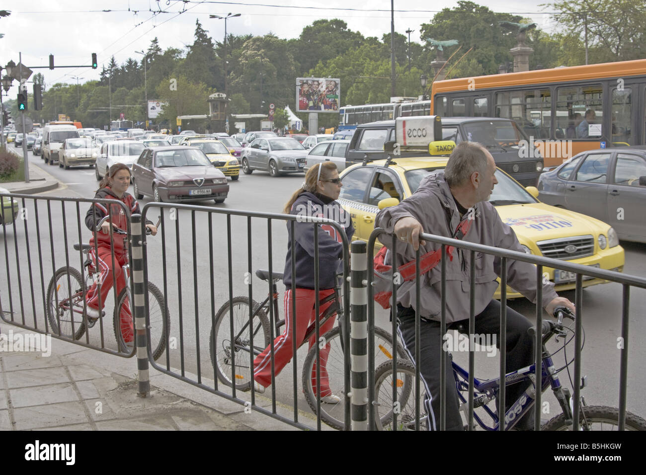 Tre i ciclisti brave il traffico nella trafficata area circostante aquile Bridge a Sofia la capitale della Bulgaria. Foto Stock