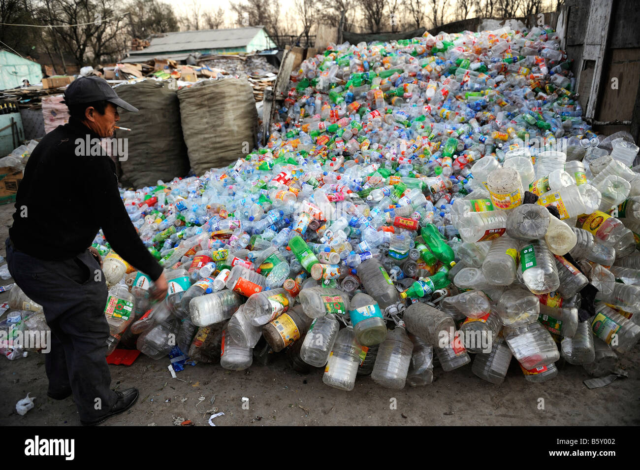 Uomo cinese raccoglie le bottiglie di plastica in corrispondenza di una stazione di recupero nella periferia di Pechino, Cina. 20-Nov-2008 Foto Stock