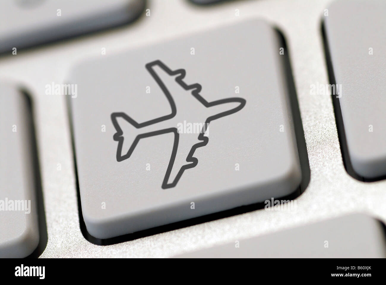 Tastiera del computer con un aereo simbolo, immagine simbolica per internet prenotazioni viaggi Foto Stock