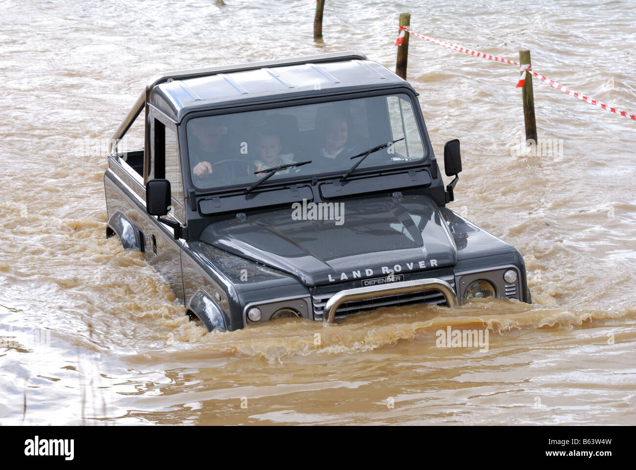 Il verde passo corto Land Rover Defender con barra stabilizzatrice in acqua in unità di fatturazione intorno a 4WD la trazione a quattro ruote motrici LRM Visualizza Foto Stock