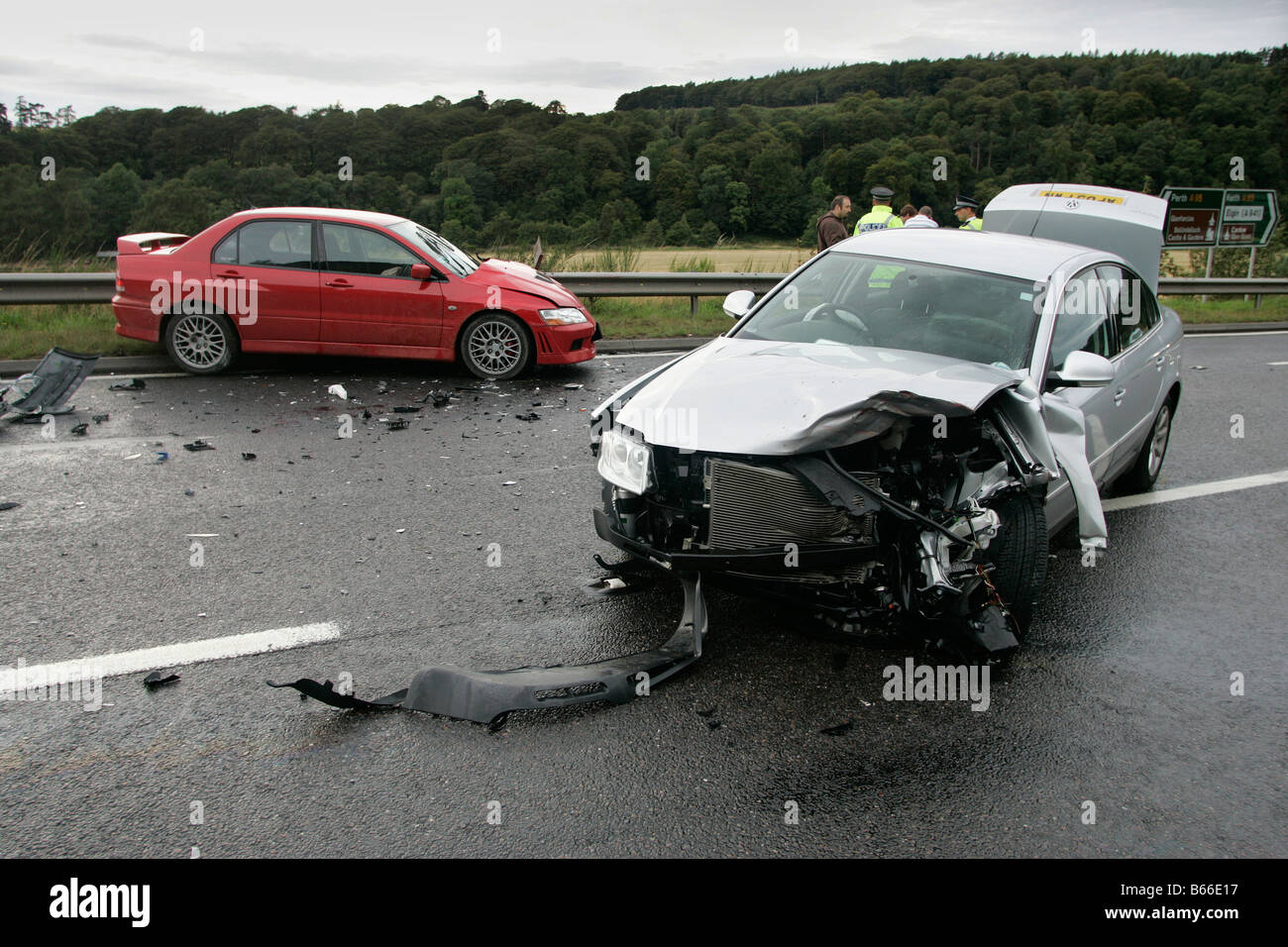 La scena di un incidente stradale che coinvolge una collisione frontale tra due vetture su una strada rurale in Scozia, Regno Unito Foto Stock