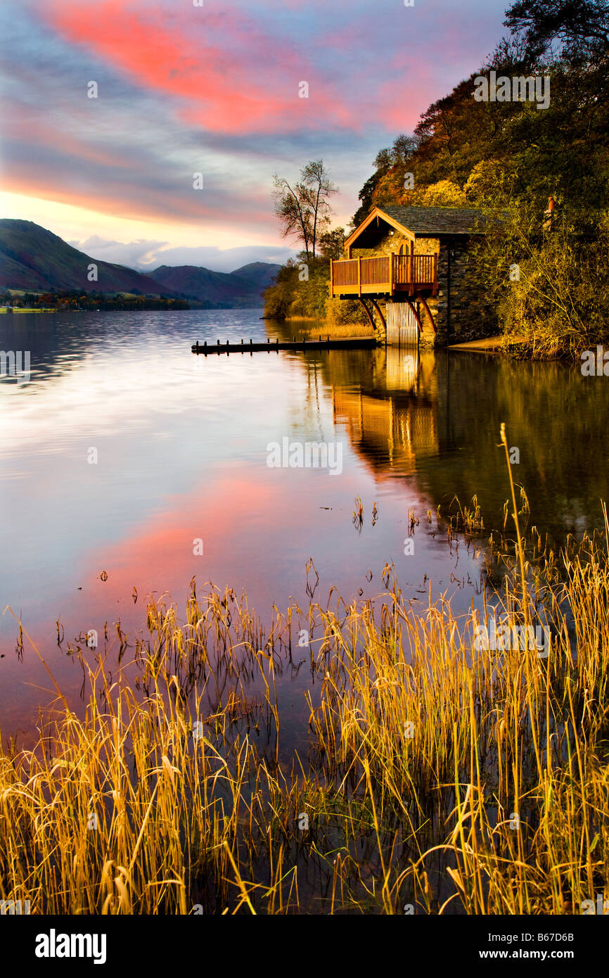 Alba la luce illumina il boathouse in legno sulla riva di Ullswater vicino Ponte Pooley, Lake District, Cumbria, England, Regno Unito Foto Stock