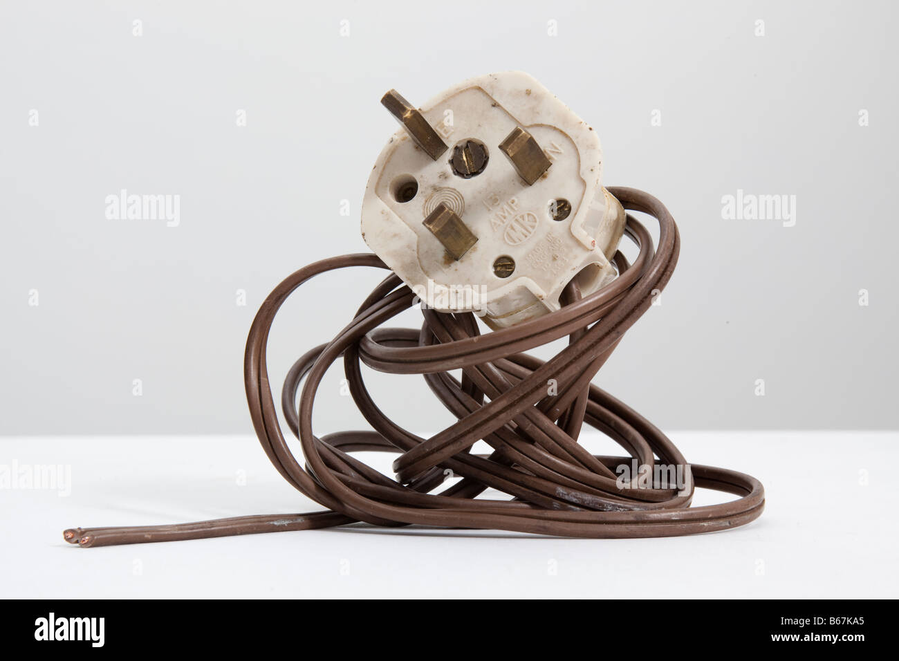 Vecchio bianco , inglese standard 13 amp spina elettrica e la bobina di marrone flex Foto Stock