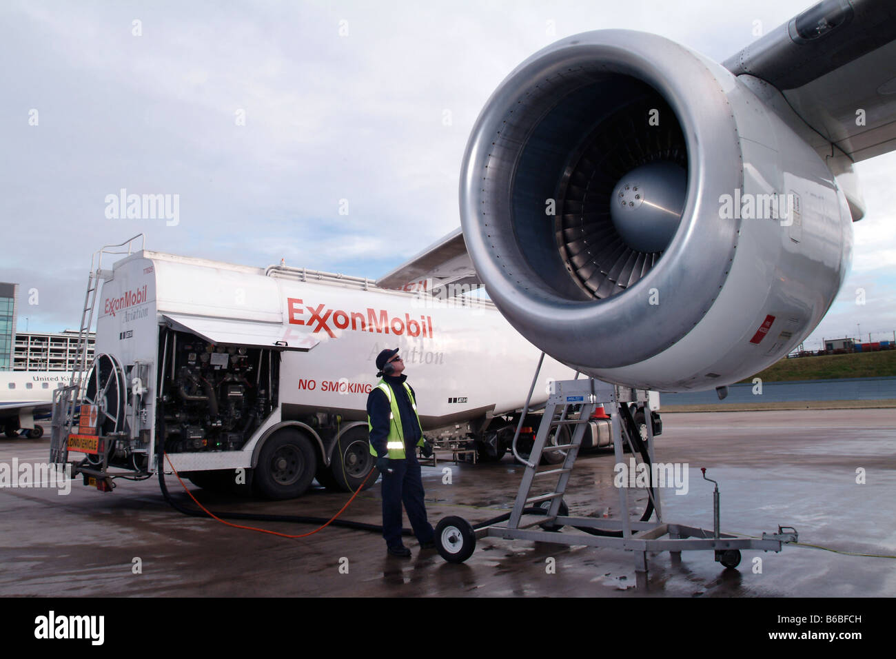ExxonMobil tecnico il rifornimento British Airways BA146 aereo all'Aeroporto di Birmingham Foto Stock