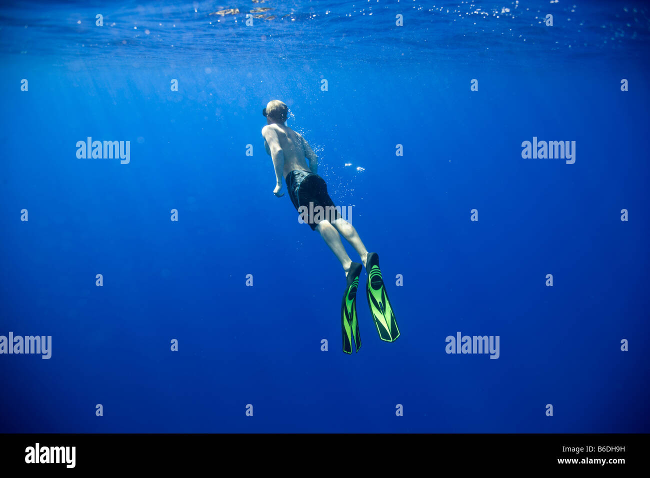 Stati Uniti Hawaii Big Island giovane uomo nuota in superficie mentre immersione libera nell'Oceano Pacifico Foto Stock