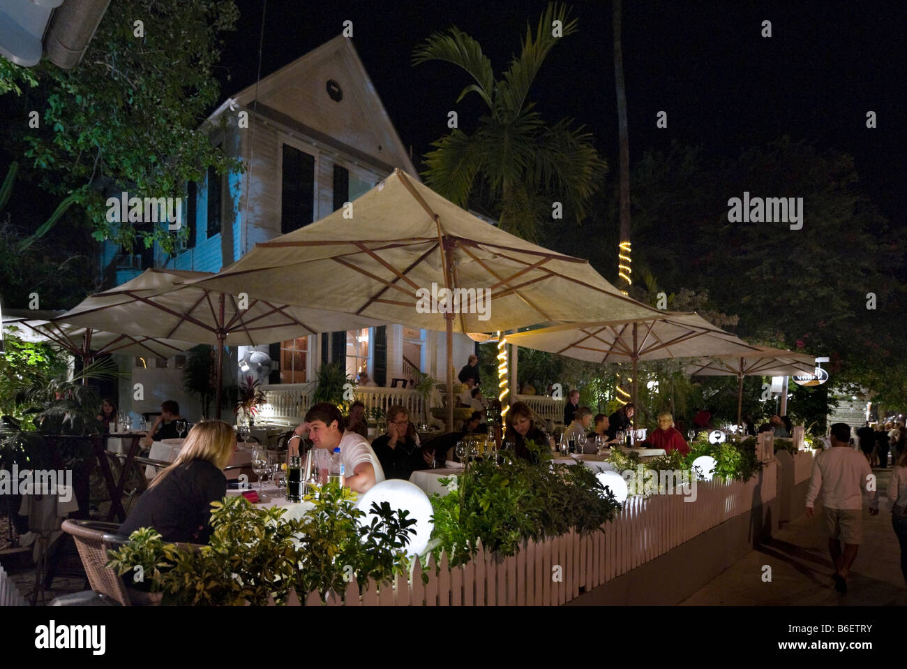 Coppia giovane presso un ristorante esterno su Duval Street di notte, Città Vecchia, Key West, Florida Keys, STATI UNITI D'AMERICA Foto Stock