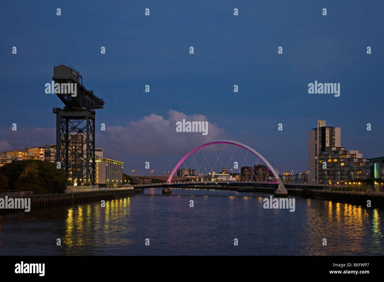 Squinty ponte che attraversa il fiume Clyde da Govan a Broomielaw in Glasgow Scotland di notte al chiaro di luna con gru Anderston Foto Stock