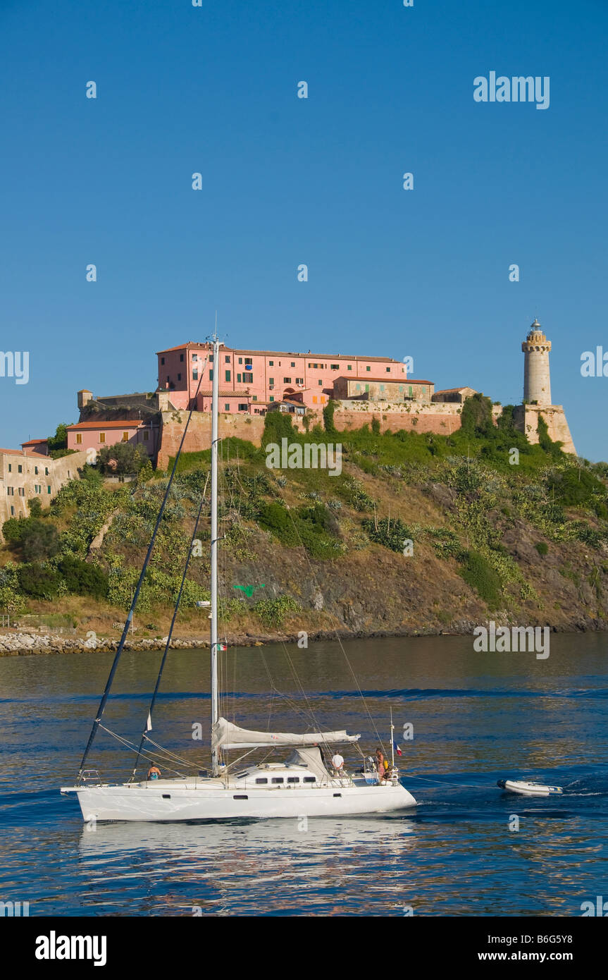 Una barca a vela di fronte a Porto Ferraio e il faro. Isola d'Elba, Toscana, Italia. Foto Stock