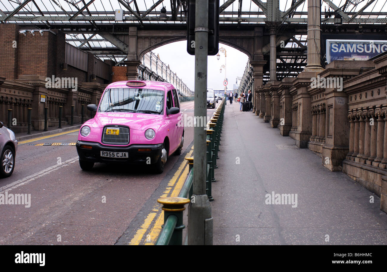 Cabina rosa, taxi a Edimburgo in Scozia, Regno Unito, aeroporto stazione ferroviaria turismo marcia, sollevamento Foto Stock