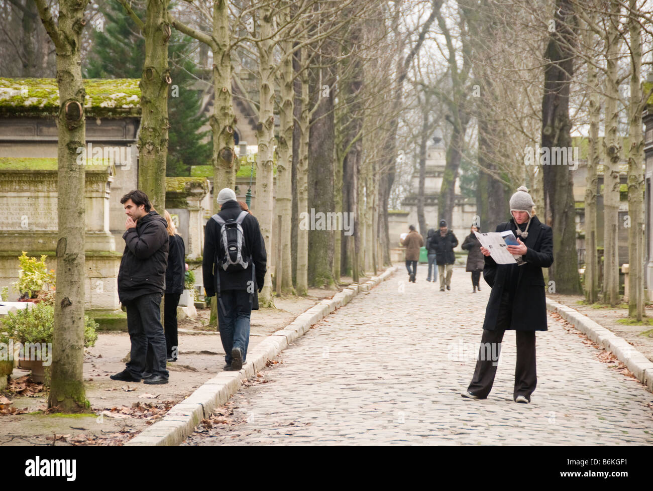 Un uomo con una mappa che mostra il punto in cui tutte le persone famose sono sepolto al cimitero di Pere Lachaise di Parigi Foto Stock