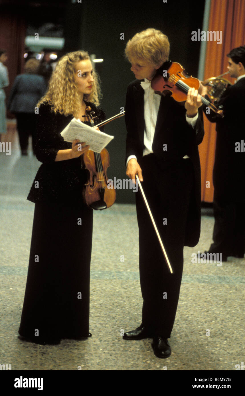 Un paio di giovani musicisti della Orchestra dei giovani in Salzau con violini, discutendo le note prima del loro prossimo aspetto Foto Stock