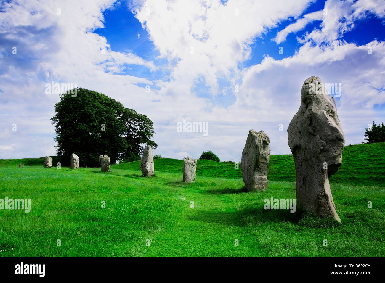Immagine guardando fuori attraverso un campo verde con le Pietre di Avebury in piedi in un semicerchio in forma Foto Stock