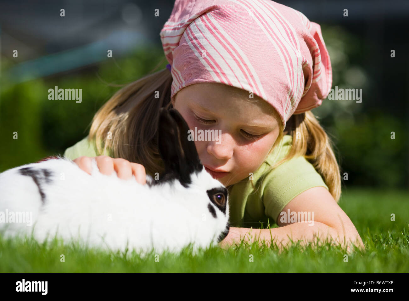 Una ragazza di accarezzare un coniglio Foto Stock
