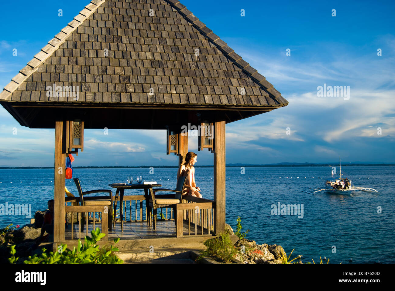 Bordo d'acqua rifugio al tramonto, Shangri-La Island Resort & Spa, Mactan Island, Cebu, Visayas, Filippine Foto Stock