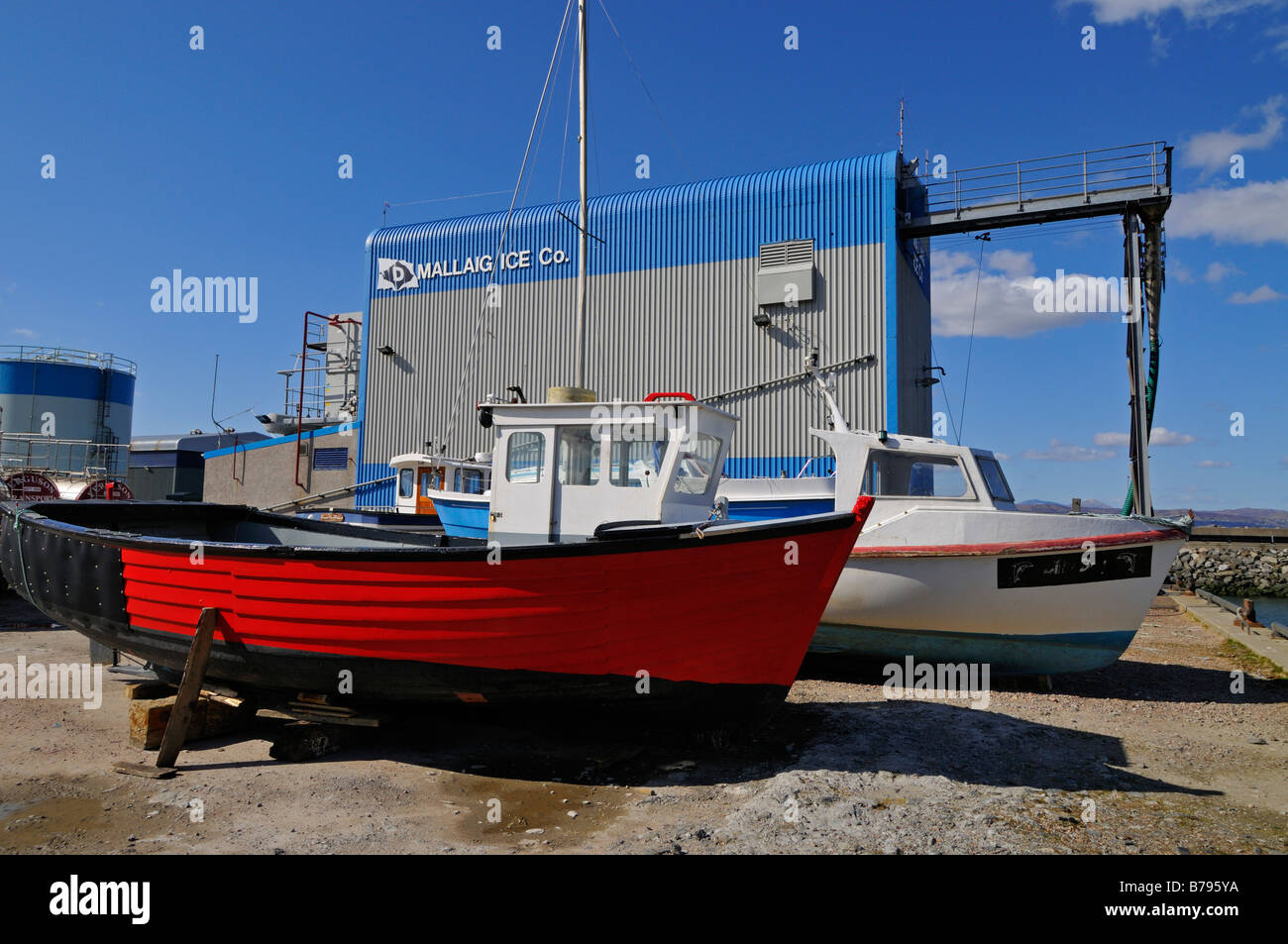 Luminose e recentemente dipinto di barca da pesca in cantiere di riparazione a Mallaig Inverness Shire Scotland Regno Unito Foto Stock