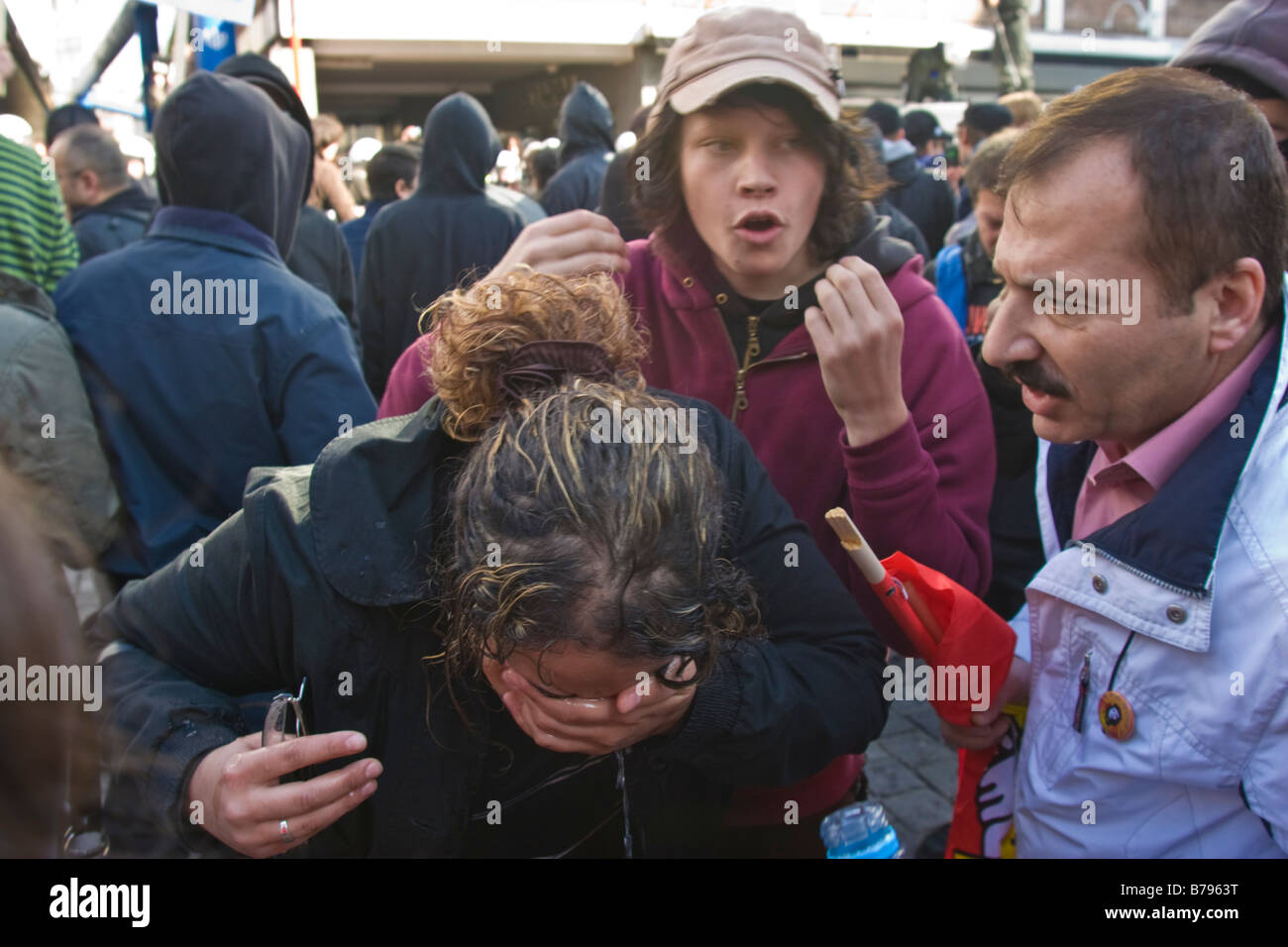 Una ragazza lava i suoi occhi dopo il lancio di gas lacrimogeni durante l attacco anti nazi dimostrazione contro Nazi riuniti a Colonia, Germania Foto Stock