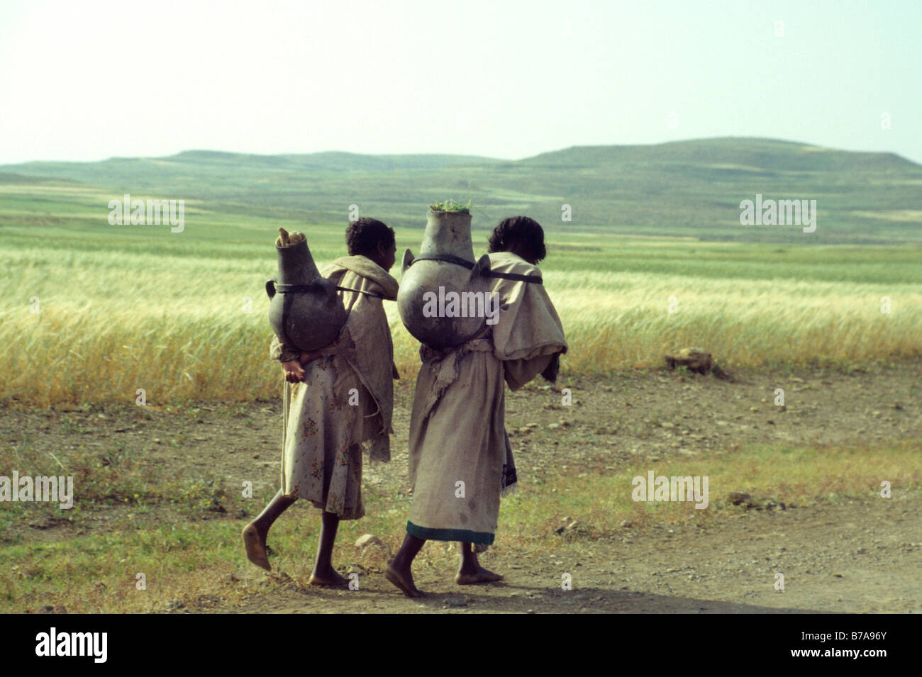 Due donne etiope che trasportano pentole di creta sulle loro spalle Foto Stock
